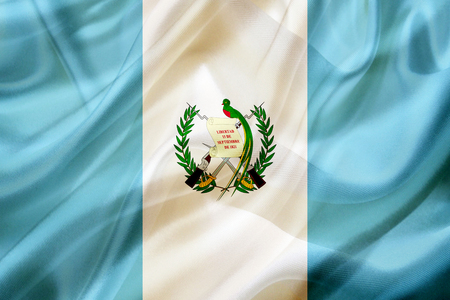 Guatemala country flag symbol on silk or silky waving texture. Smooth fabric or materialの写真素材