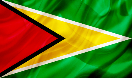 Guyana country flag symbol on silk or silky waving texture. Smooth fabric or materialの写真素材