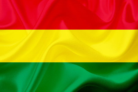 Bolivia country flag symbol on silk or silky waving texture. Smooth fabric or materialの写真素材