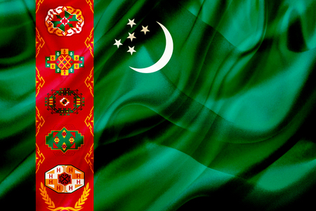 Turkmenistan country flag symbol on silk or silky waving texture. Smooth fabric or materialの写真素材