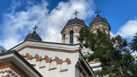 Classical old romanian christian orthodox church with blue sky and clouds