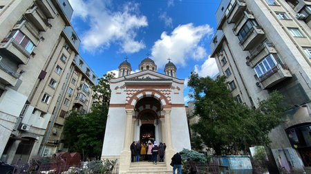 Classical old romanian christian orthodox church with blue sky and cloudsの写真素材