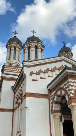 Classical old romanian christian orthodox church with blue sky and clouds