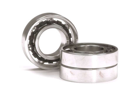Ball bearing behind a stack of two ball bearings isolated on white backgroundの写真素材