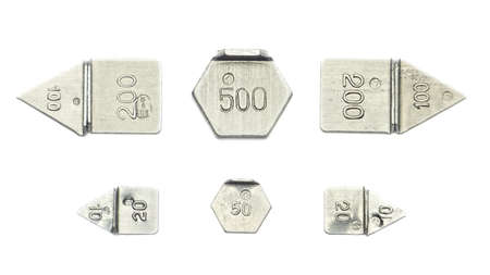 Six buttons arranged from ten calibration weights from 10mg to 500mg isolated on white backgroundの写真素材