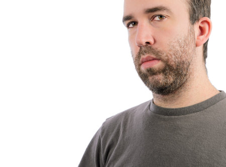 A serious man with a beard, isolated on a white background 