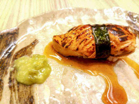 foie gras sushi wrapped in algae and special sauce.Served with wasabi.It has a unique flavor, unlike other types of food.の写真素材