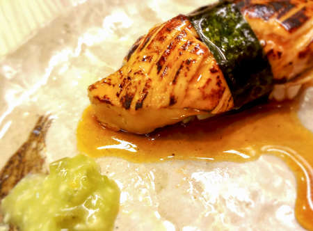 foie gras sushi wrapped in algae and special sauce.Served with wasabi.It has a unique flavor, unlike other types of food.の写真素材