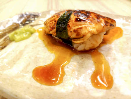 foie gras sushi wrapped in algae and special sauce.Served with wasabi.It has a unique flavor, unlike other types of food.の写真素材