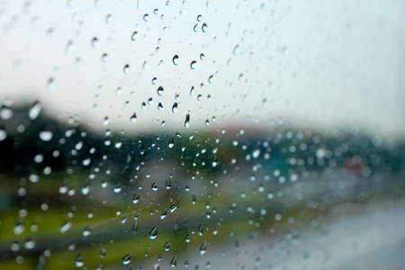 Raindrops on the window show the weather in the rainy season.の写真素材