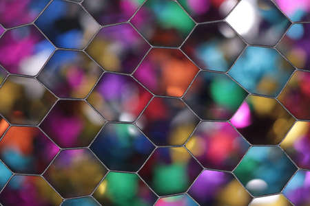 Colorful bokeh background photographed through a honeycomb grid diffuserの写真素材