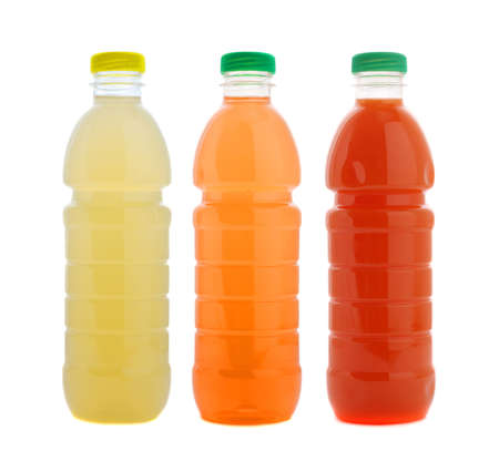 Three juice bottles of different colors isolated on white. Studio shot.の写真素材