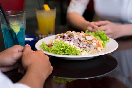 Close-up of people having a meal in a restaurantの写真素材
