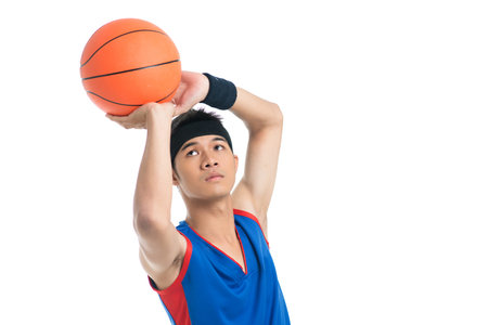 Isolated image of a basketball player being about to throw a ballの写真素材