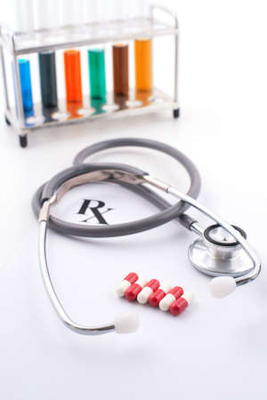 Close-up of stethoscope and capsules isolated on whiteの写真素材