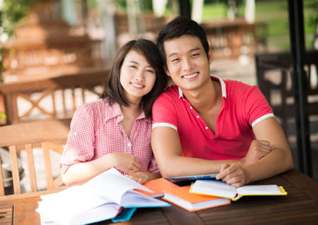 Charming students dating in a summerhouse preparing for examの写真素材