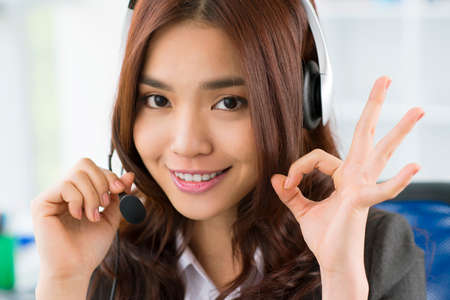 Close-up portrait of a charming office girl providing online consultancyの写真素材