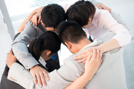 Business team performing their traditional ritual to enhance team-spiritの写真素材