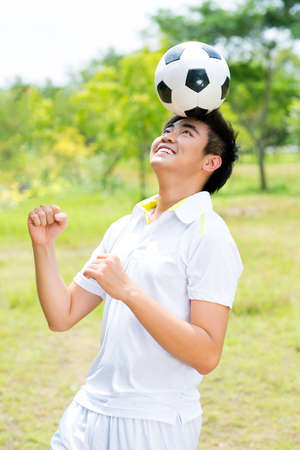 Vertical shot of a footballer playing the ball with his headの写真素材