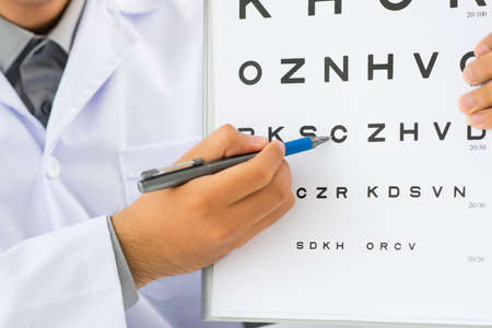 Doctor pointing at eye chartの写真素材