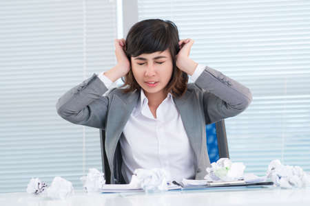 Young business woman experiencing nervous breakdownの写真素材