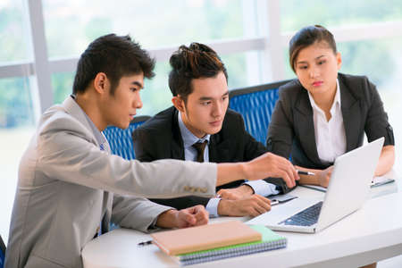 Business workgroup holding a meeting to consider available options of strategic developmentの写真素材