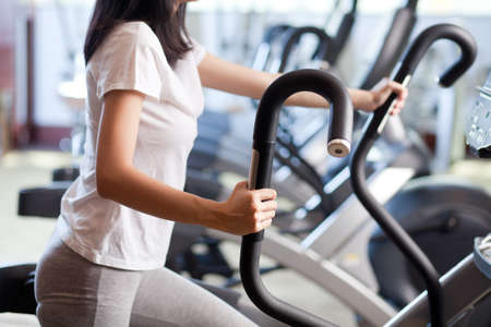 Woman exercising on a cardio machineの写真素材