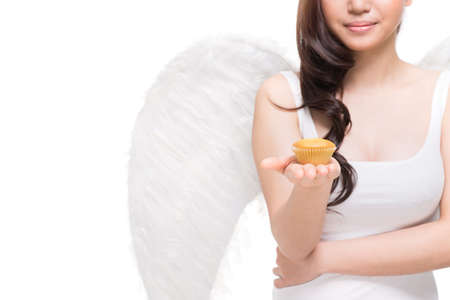 Angel sharing a taste of heaven by giving a small cakeの写真素材
