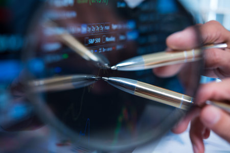Close-up of a pen pointed at a computer screen
