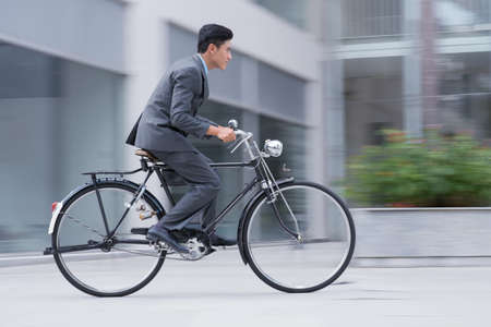 Profile image of an active businessman riding a bicycle on the way to jobの写真素材