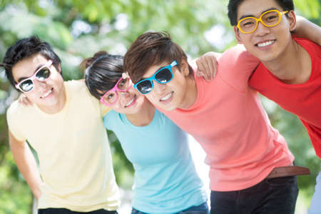 Image of friend?s team embracing outdoorsの写真素材