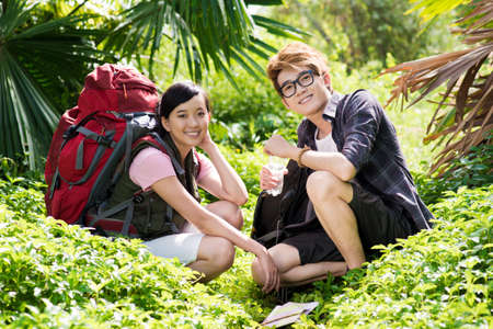 Portrait of a young happy tourist couple taking rest in the forestの写真素材