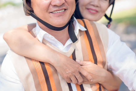 Close-up image of a mature couple where a wife hugging his husband on the foregroundの写真素材