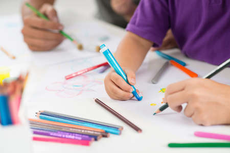 Close up image of human hands painting something on the foreground の写真素材
