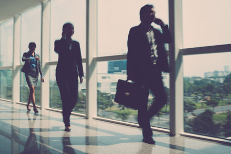 Blurry image of businesspeople being in a hurry indoors