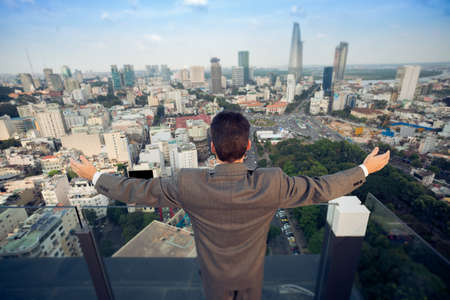 Above view of a businessperson standing with the hands up in the sign on success の写真素材