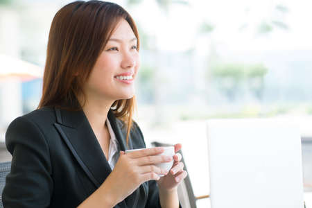Lovely lady with confident smile enjoying her teaの写真素材