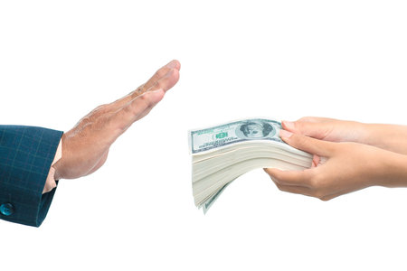 Close up of a hand refusing a bribe