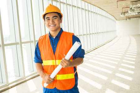Copy-spaced portrait of a young engineer smiling and looking at cameraの写真素材