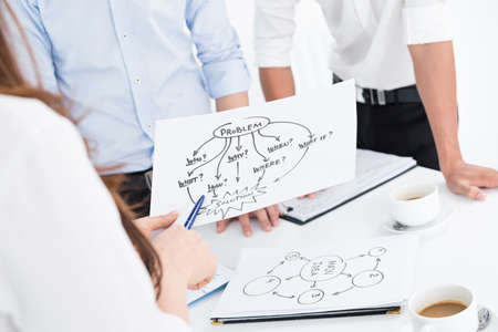 Closeup of business team working with the schemeの写真素材