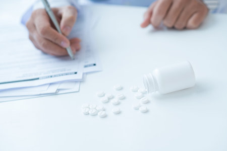 Image of male hands filling in the medical insurance formの写真素材