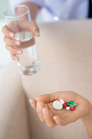 Close-up of human hands taking pills and drugs insideの写真素材