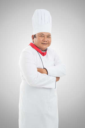 Isolated portrait of a chef-cook smiling and looking at cameraの写真素材