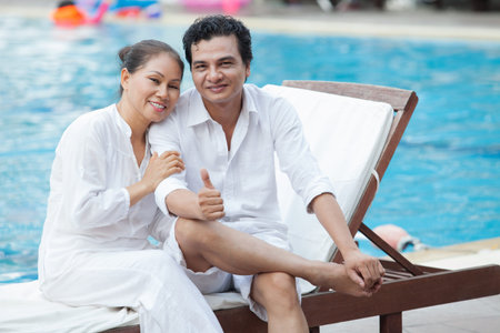 Portrait of a happy senior couple in the swimming poolの写真素材