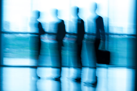 Image of blurred business people standing at the officeの写真素材