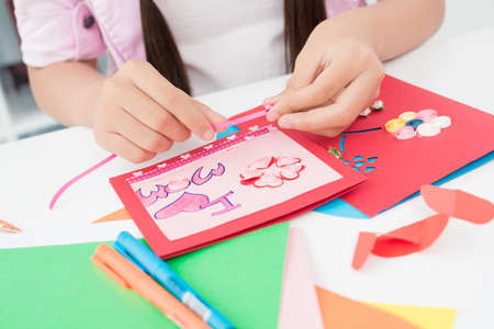 Close-shot of female hands scrapbooking at tableの写真素材