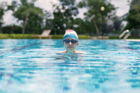 Image of a young girl swimming in the pool in the surfaceの写真素材