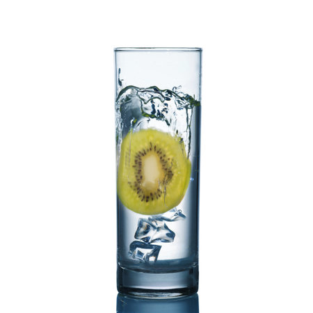 Isolated image of a glass of fresh water with kiwi and ice in itの写真素材