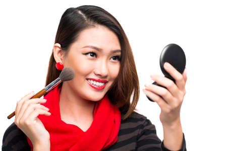 Close-up image of a young attractive woman preparing for a New Year Party against a white backgroundの写真素材