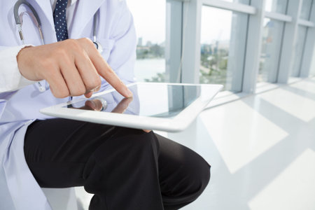 Copy-spaced image of male hands touching a tablet 
